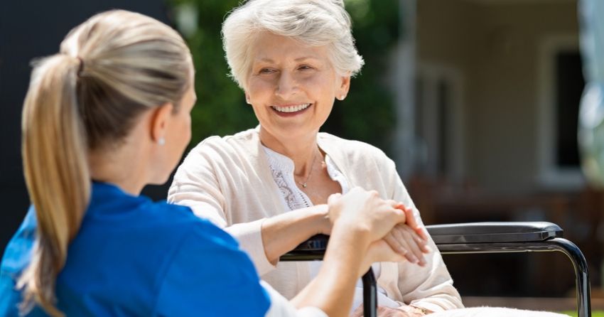 nurse helping elderly patient