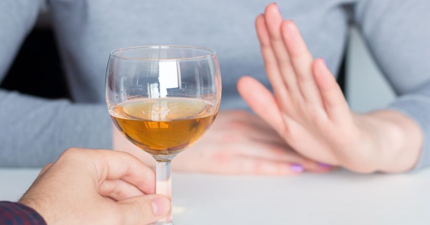 woman refusing wine, alcohol consumption
