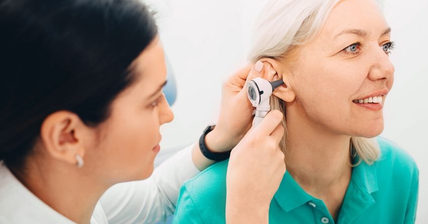 ear exam on woman, hearing test, hearing loss
