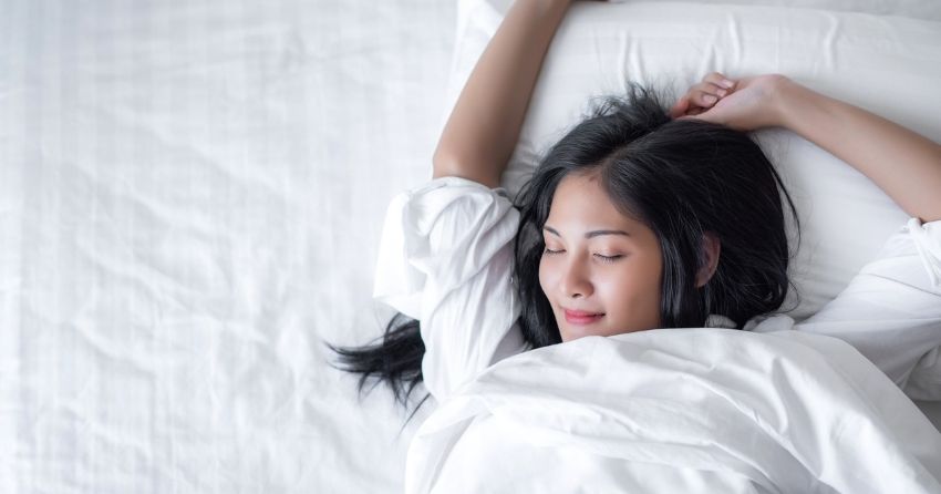 woman getting a good nights' sleep; how well we sleep today may predict future Alzheimer's risk 
