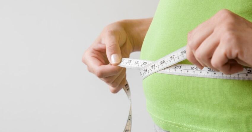 overweight woman with measuring tape