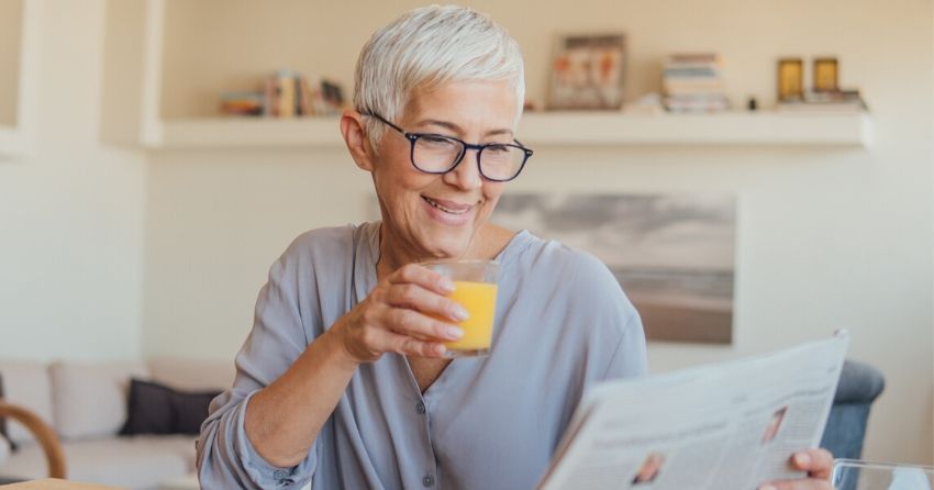 senior woman reading; remaining engaged during retirement can protect against cognitive decline