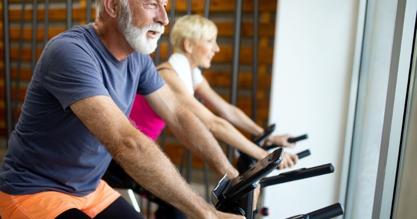 seniors on stationary exercise bike, cardiorespiratory exercise
