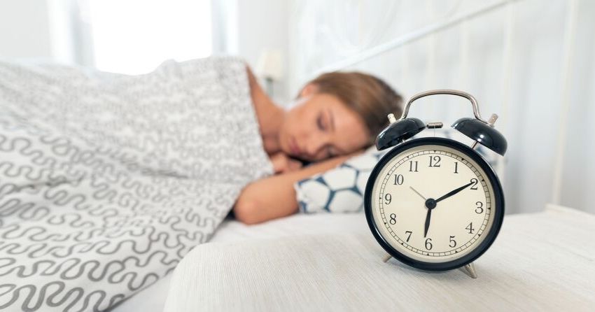 woman sleeping with clock